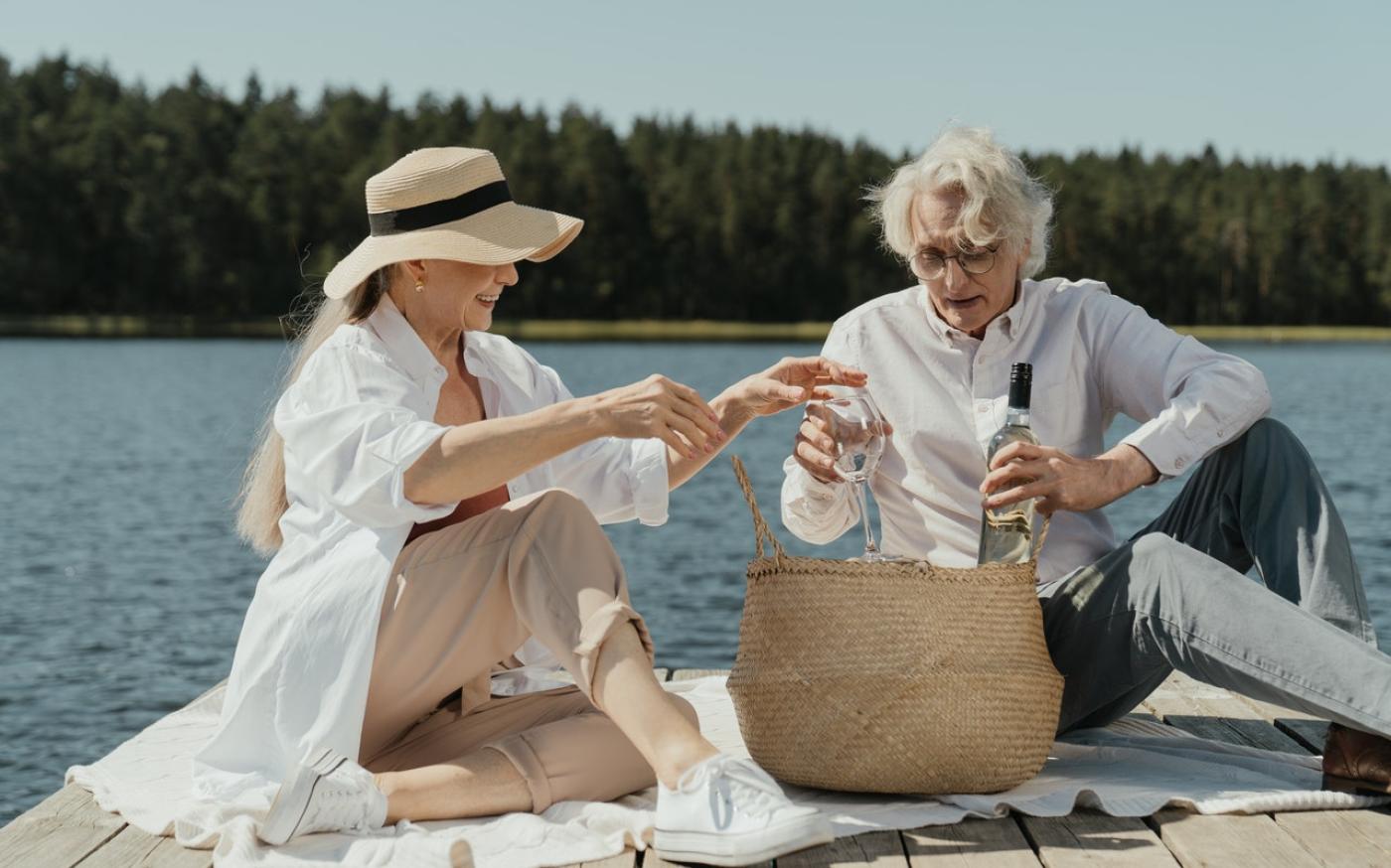 Two people having a picnic by a lake